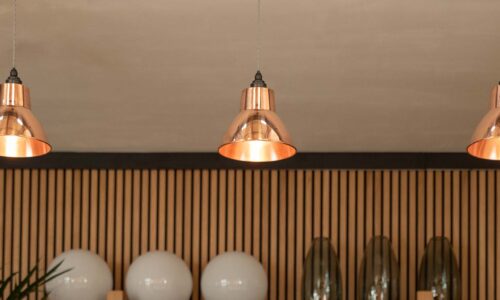 Three Moccas copper pendant lights over kitchen island