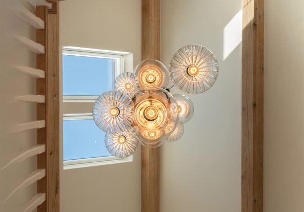 Stairwell lighting with a multi pendant chandelier