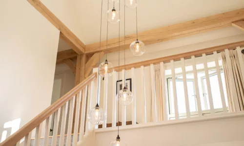 A staged cluster chandelier in a Border oak home featuring Fritz Fryer Lighting