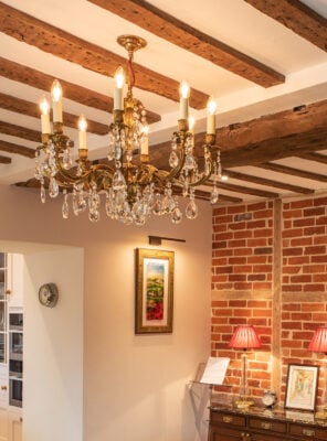 A restored antique pendant hung in a traditional cottage and restored by Fritz Fryer lighting