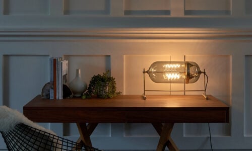 Aston smoked table lamp is perfect for any room, whether commercial or private, providing a warm glow.