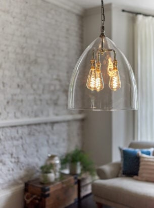 Large glass lantern with multiple lamp holders featured within a modern living room, designer lanterns make a great addition to larger areas such as the living room.