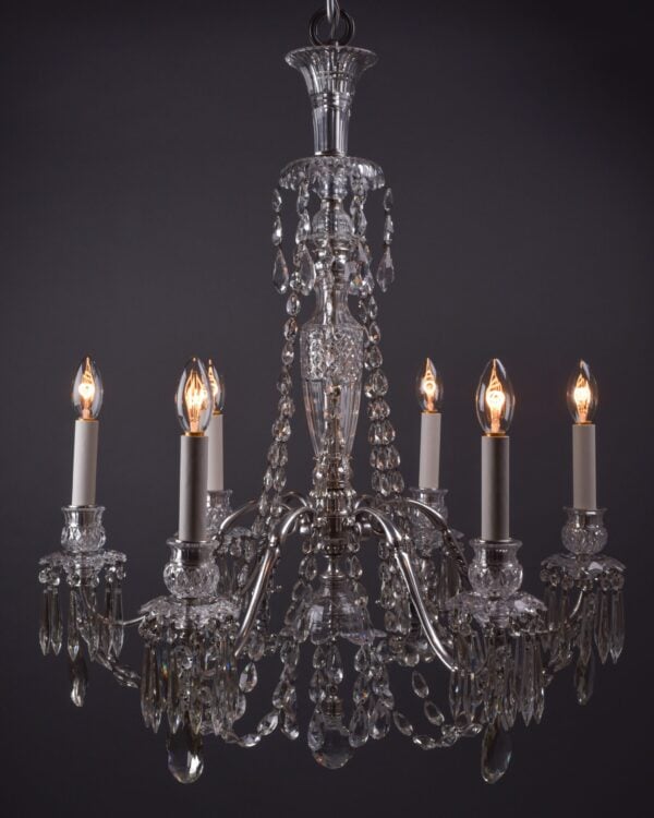 Antique crystal chandelier made by F&C Osler with 6 silver plate arms on a dark background