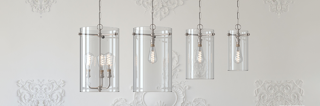 Sellack lanterns hung in a row in Clear-glass showing the different sizes against a white wall