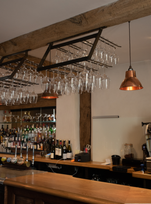 The Copper pendant lights installed here over a bar at the New Inn in Herefordshire light the space perfectly