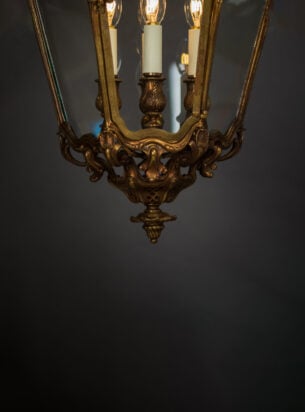 Antique lanterns make a beautiful addition to a hallway, featured here is an ornate gilt antique lantern