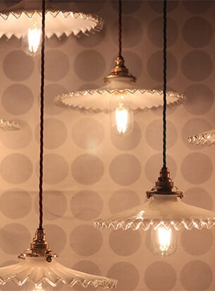 Antique French frilled pendant lights suspended on handmade pendant sets, illuminated by LED bulbs.