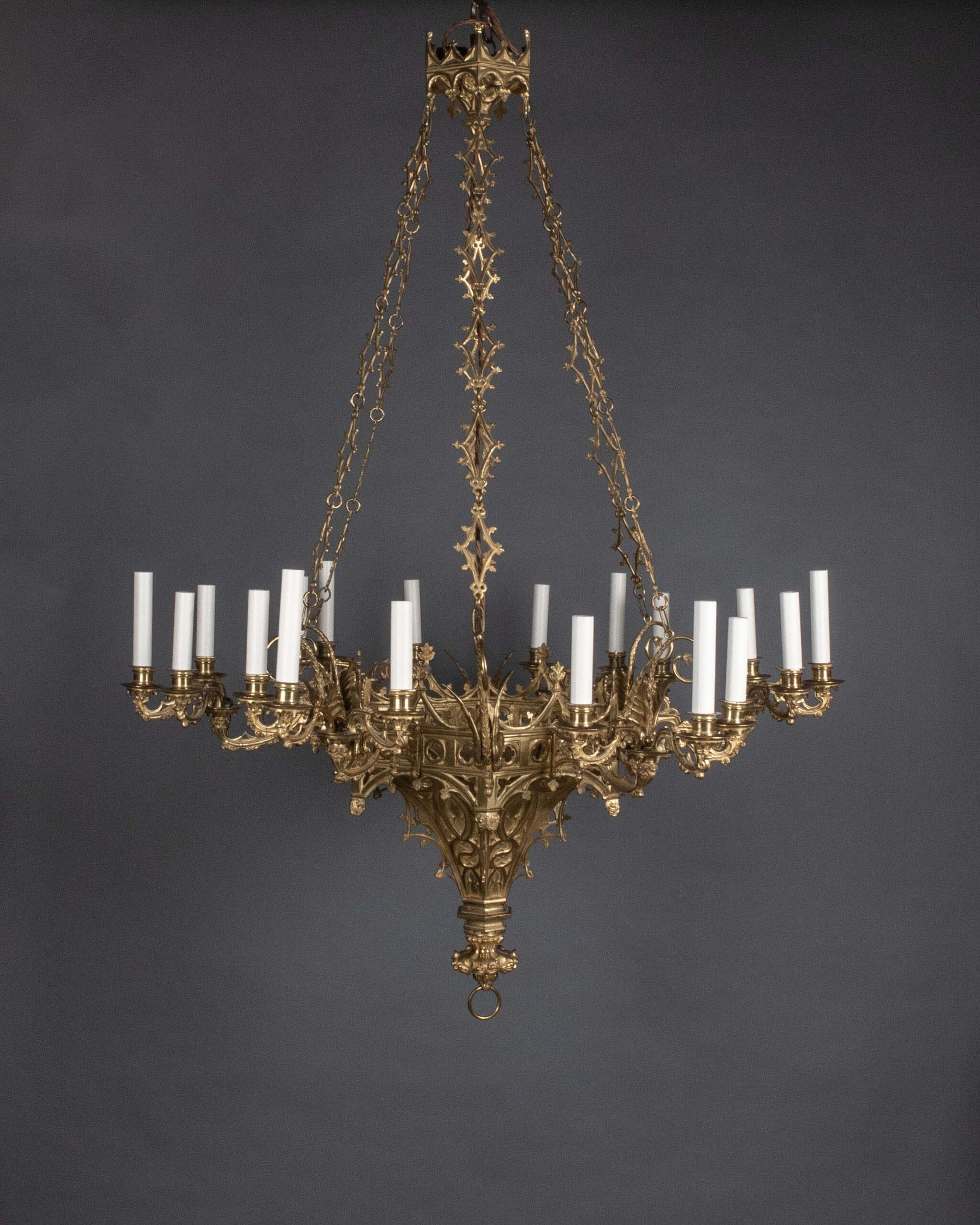 Magnificent gothic revival gilt chandelier on a grey background with multiple branches