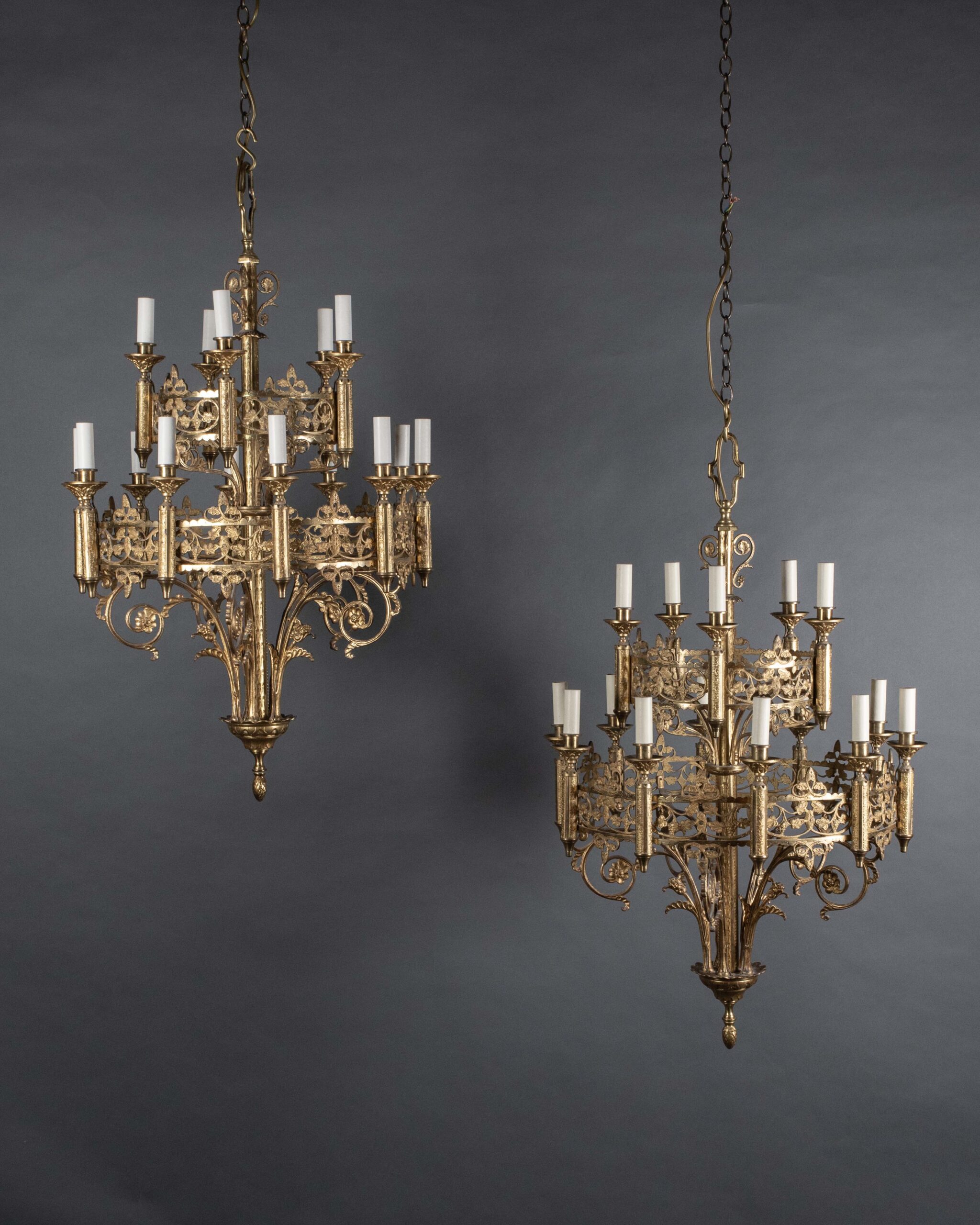 Pair of ornate gothic chandeliers made of gilt with 2 tiers hung side by side