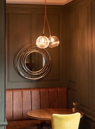 3 ribbed globe pendants hung as a pub cluster light against dark wood panelling