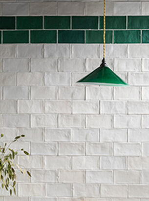 White and green tiled kitchen wall paired with a green glass pendant light, vintage pendant lighting is a practical addition to the kitchen.