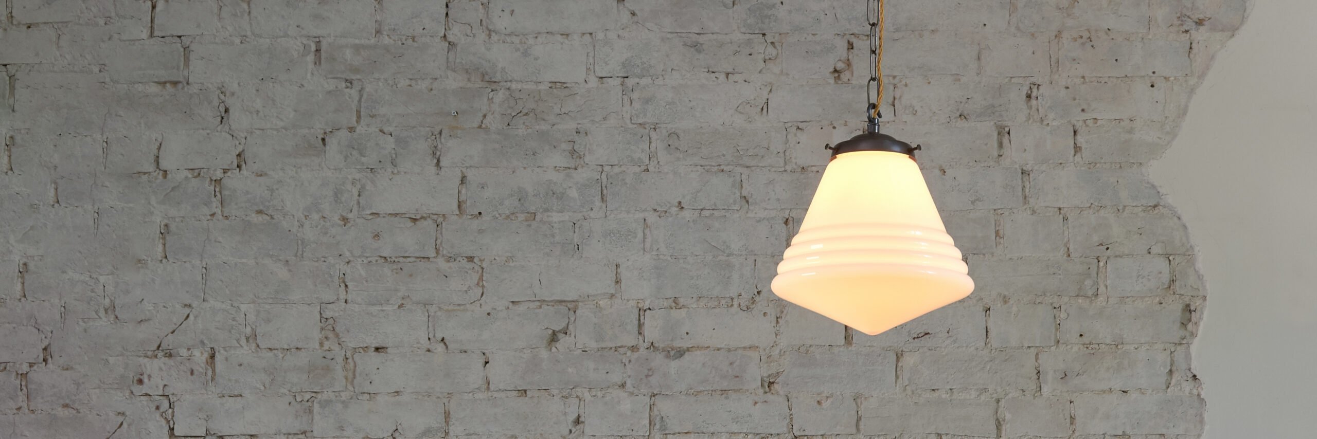 Retro lights against a white brick wall. A perfect lighting addition both for residential or commercial spaces.