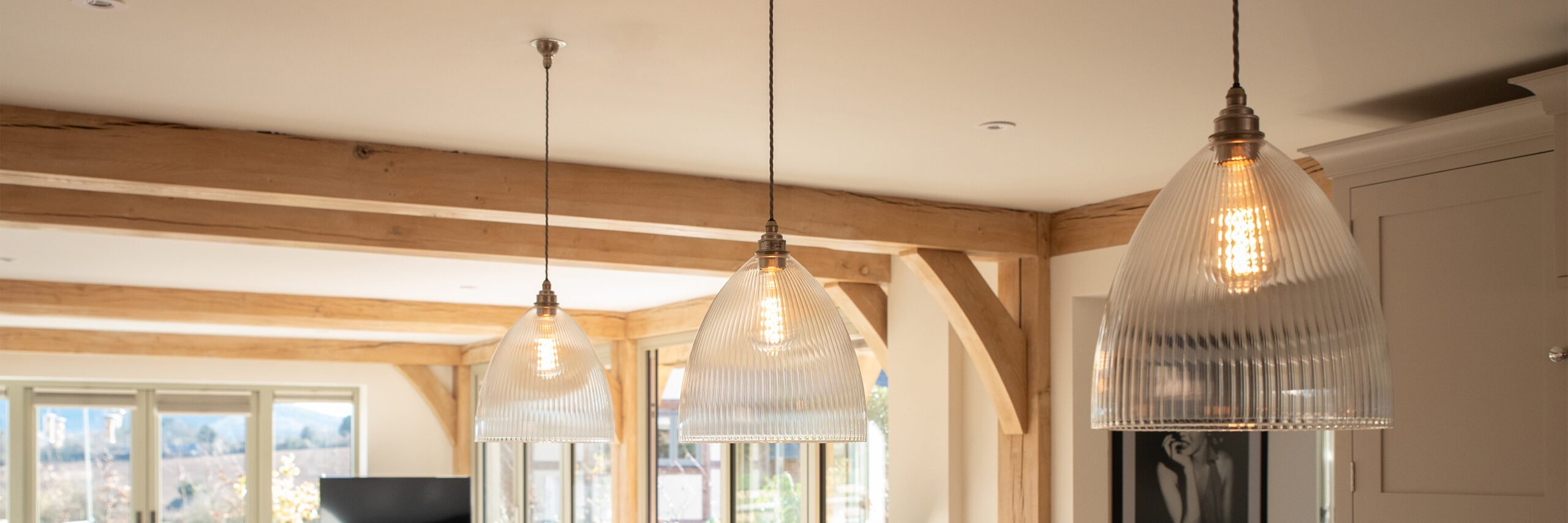 Three clear ribbed Ledbury pendant lights from Ledbury lighting collection, enhancing the ambiance of a restaurant. Ideal for both commercial and private settings.
